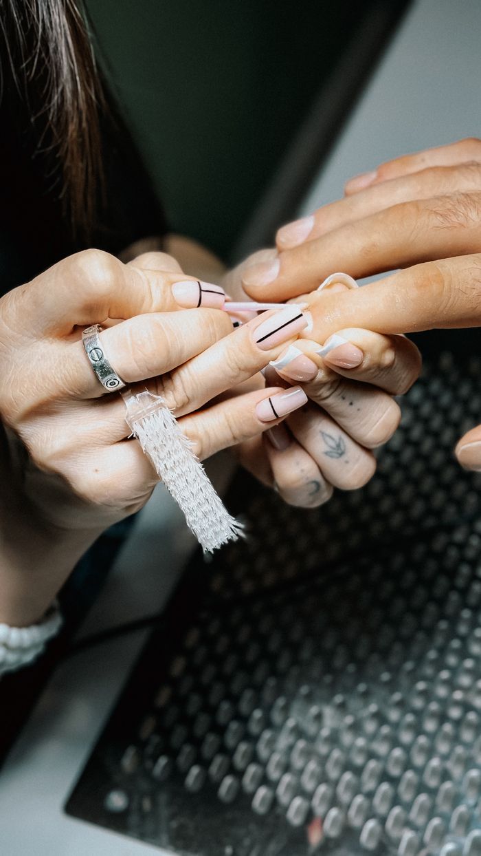 Close-up of a detailed manicure process in a nail salon.